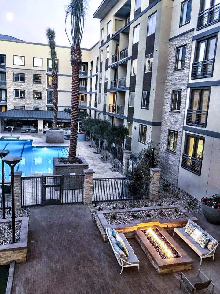 Cozy outdoor fire pit area at Peak 16 Apartments, ideal for evening gatherings in a luxurious setting