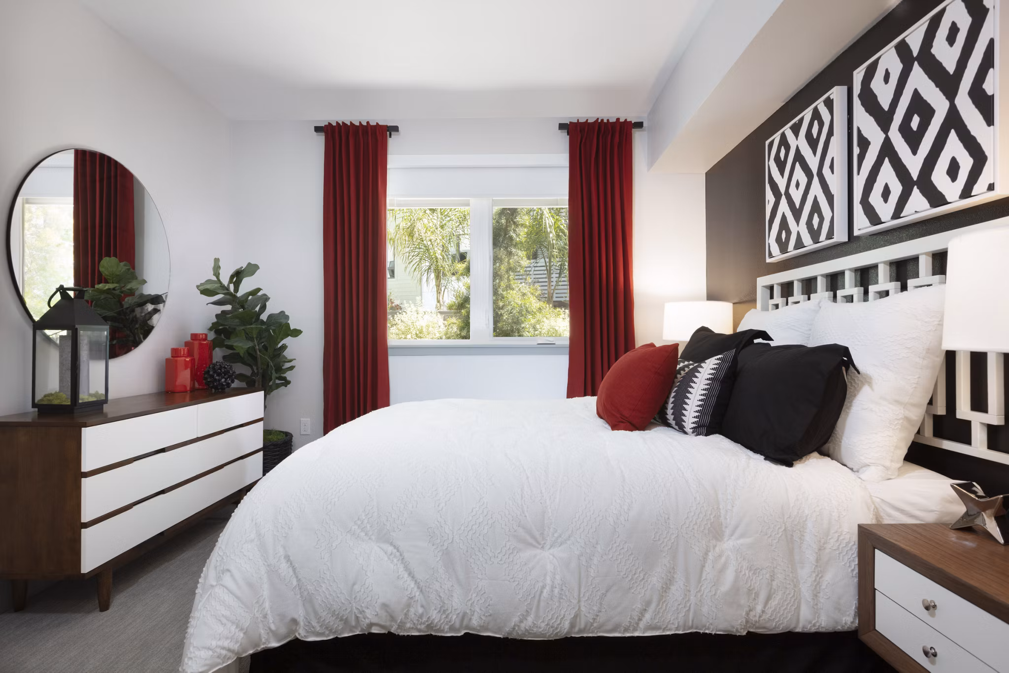 Cozy bedroom with modern furnishings and large windows at Vaya Apartments