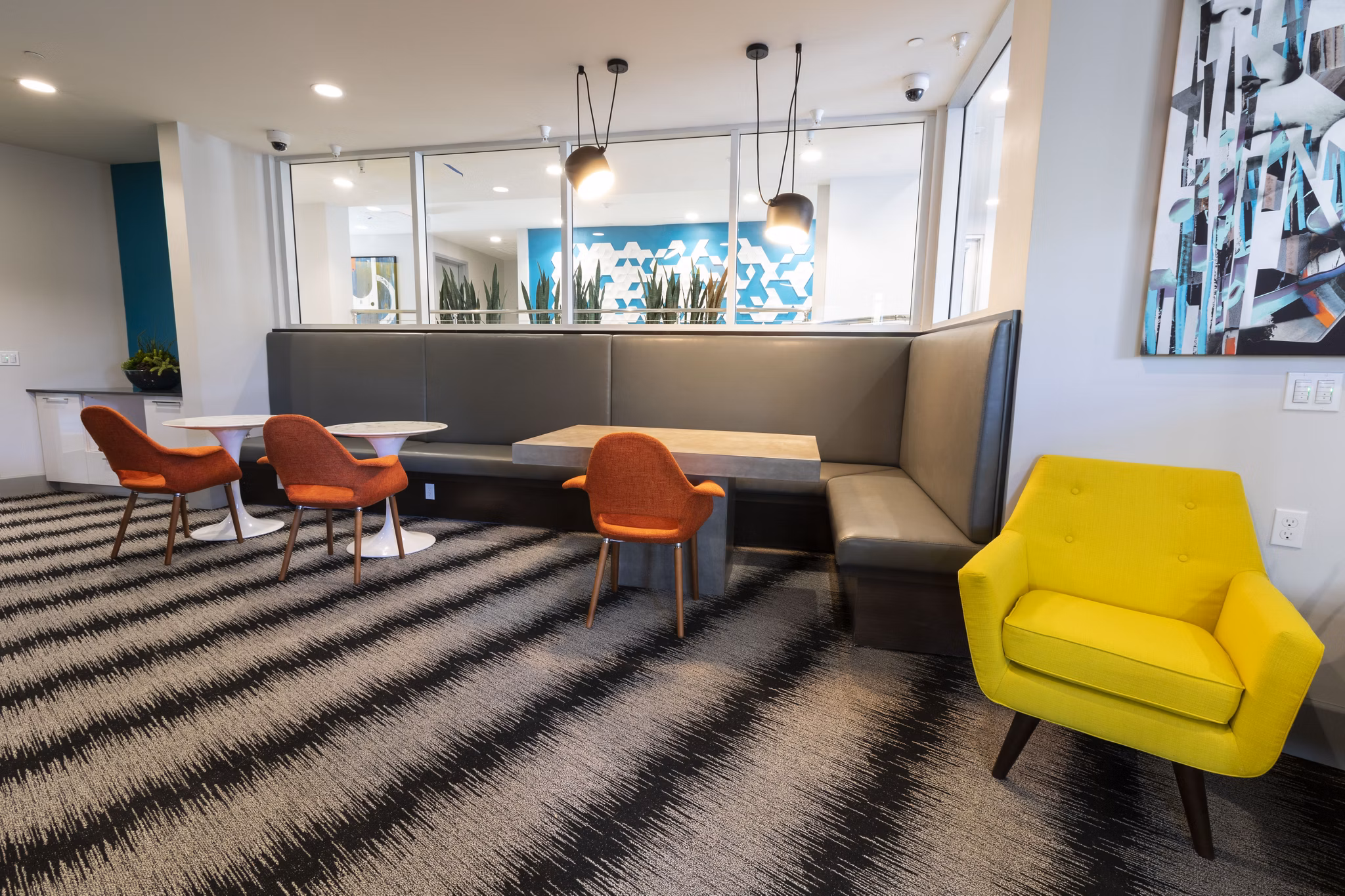 Modern clubhouse with elegant seating and large screen TV at Vaya Apartments, a Greystar luxury community in the heart of the city