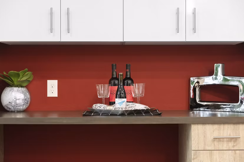 Modern kitchen with stainless steel appliances and quartz countertops in Vaya Apartments