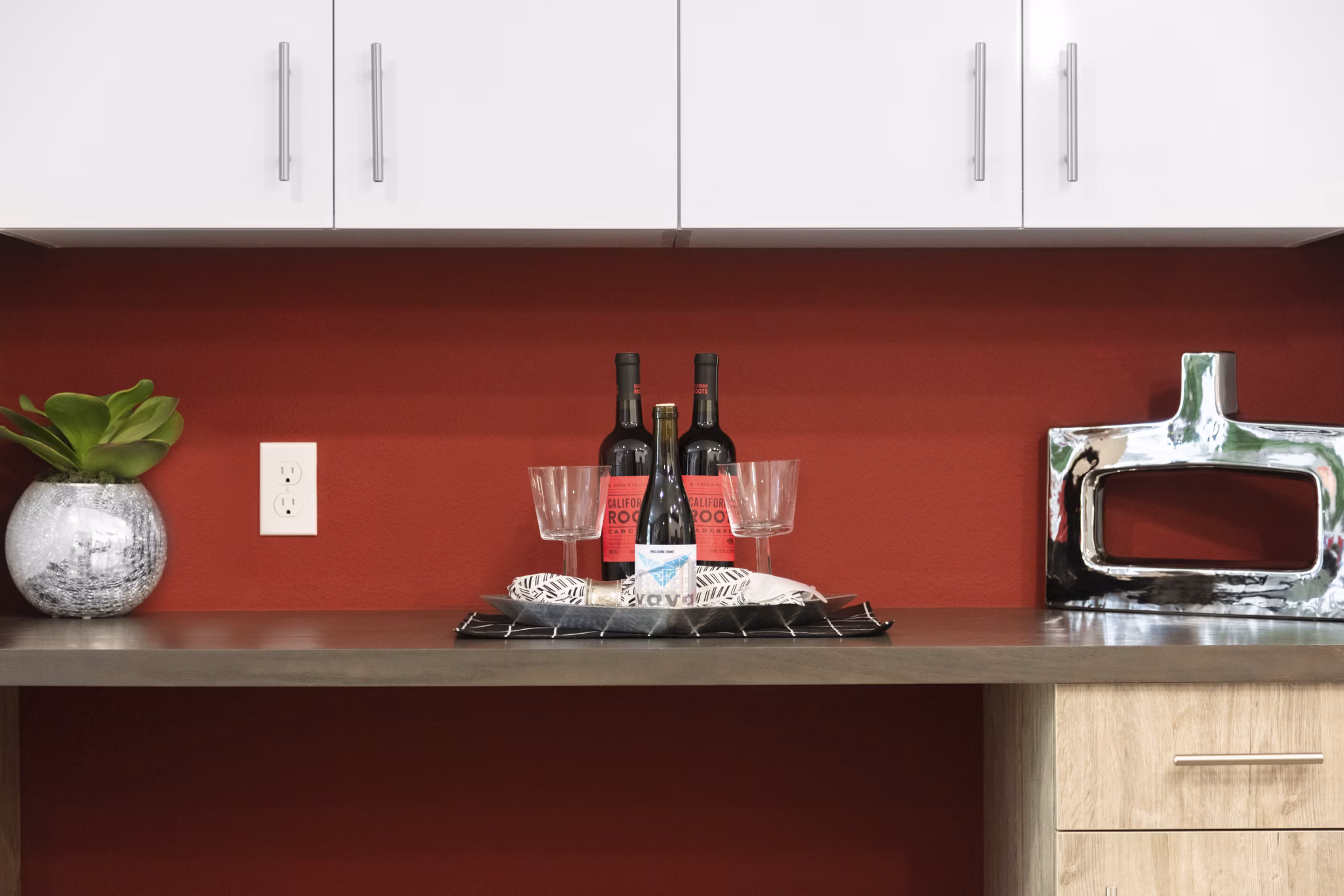 Modern kitchen with stainless steel appliances and quartz countertops in Vaya Apartments