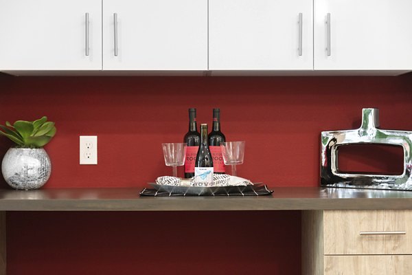 Modern kitchen with stainless steel appliances and quartz countertops in Vaya Apartments