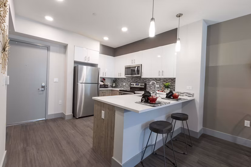 Modern kitchen with stainless steel appliances in Vaya Apartments, offering luxury living by Greystar