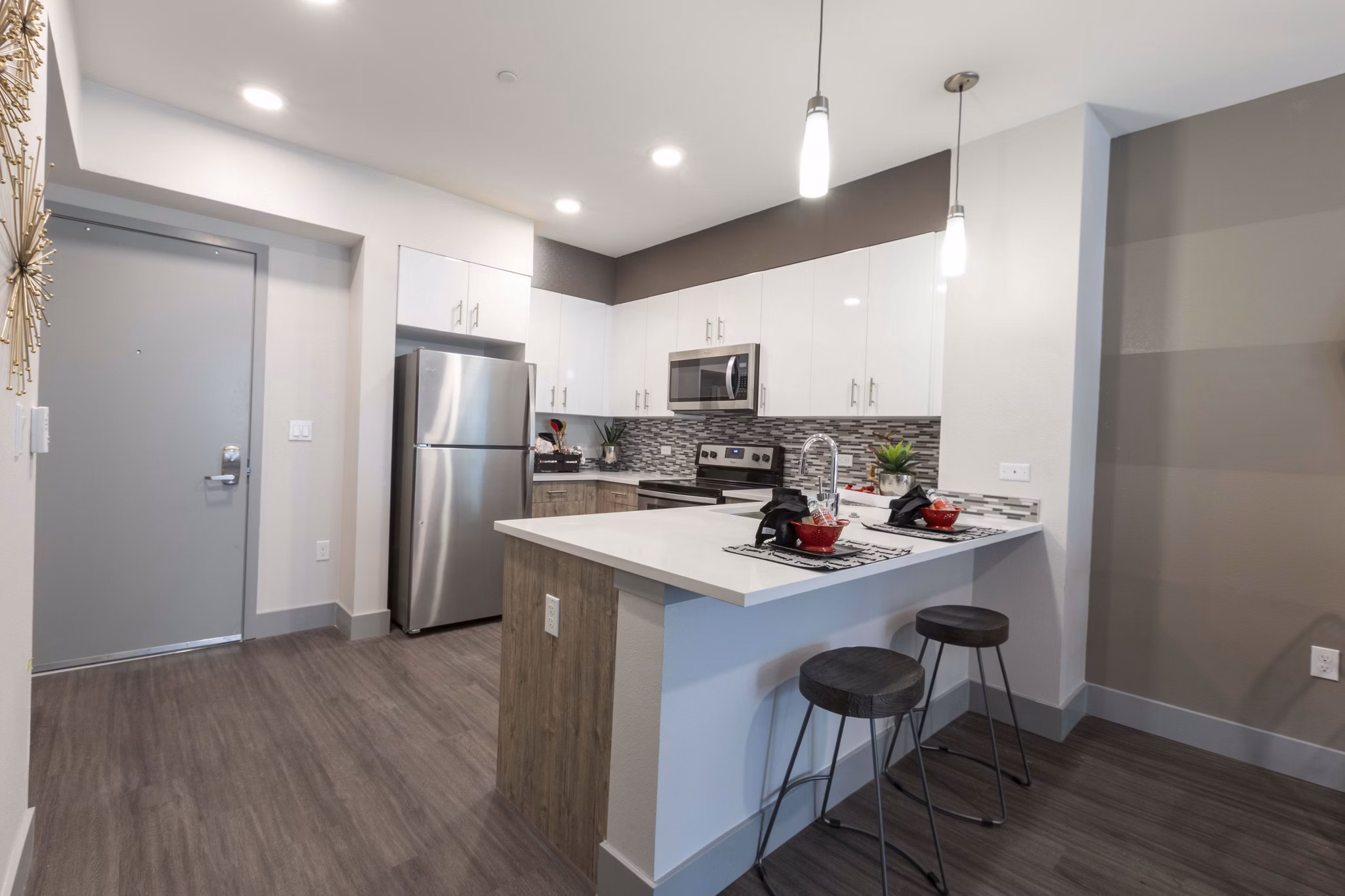 Modern kitchen with stainless steel appliances in Vaya Apartments, offering luxury living by Greystar