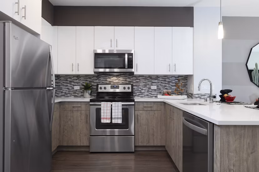 Modern kitchen with stainless steel appliances at Vaya Apartments, luxury living spaces in vibrant city setting