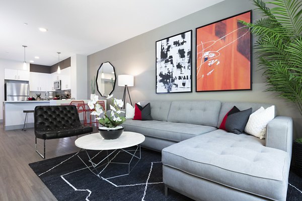 Cozy living room with plush seating and modern decor in Vaya Apartments