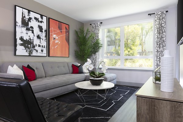 Spacious living room with modern decor and large windows at Vaya Apartments offering luxury living