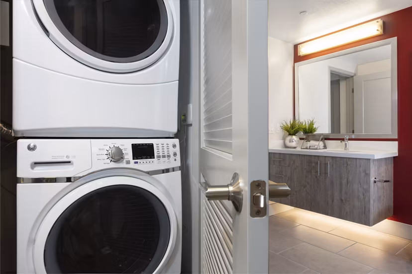 Vaya Apartments: Modern laundry room with high-efficiency machines and folding station