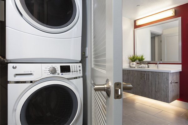 Vaya Apartments: Modern laundry room with high-efficiency machines and folding station