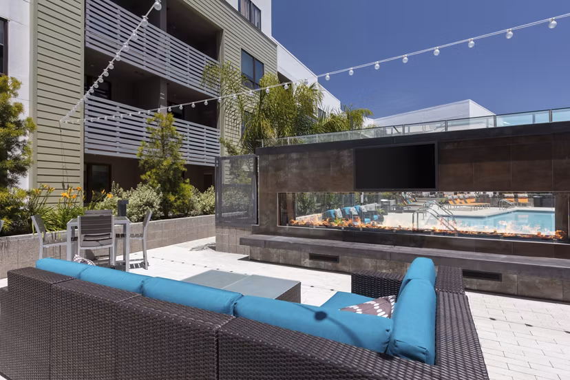 Patio with modern seating and outdoor fireplace at Vaya Apartments in a luxurious Greystar community