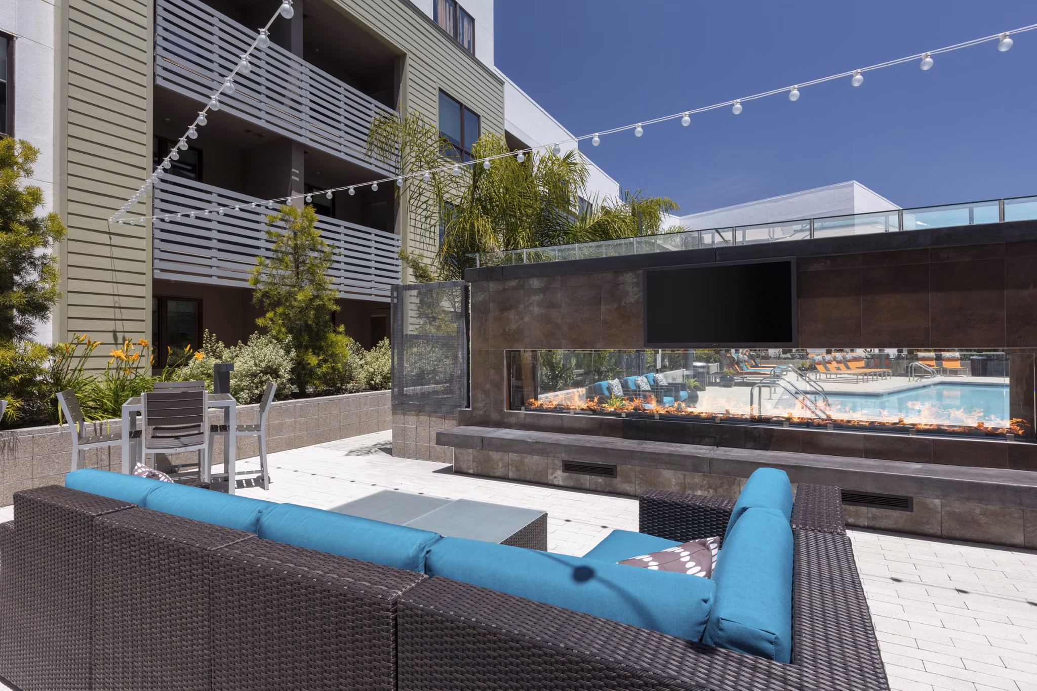 Patio with modern seating and outdoor fireplace at Vaya Apartments in a luxurious Greystar community