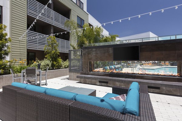 Patio with modern seating and outdoor fireplace at Vaya Apartments in a luxurious Greystar community