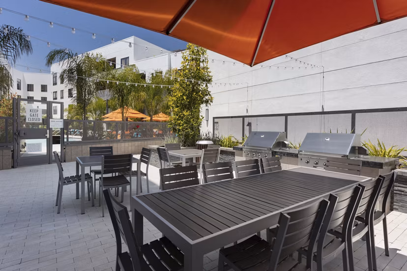 Outdoor grill area with modern seating at Vaya Apartments, a luxury community by Greystar