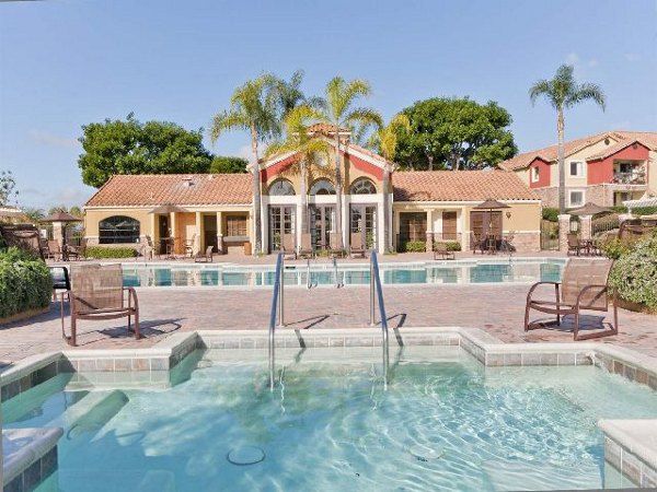 Serene pool oasis at Overlook at Bernardo Heights Apartments with surrounding lounge chairs and lush landscaping, perfect for relaxation