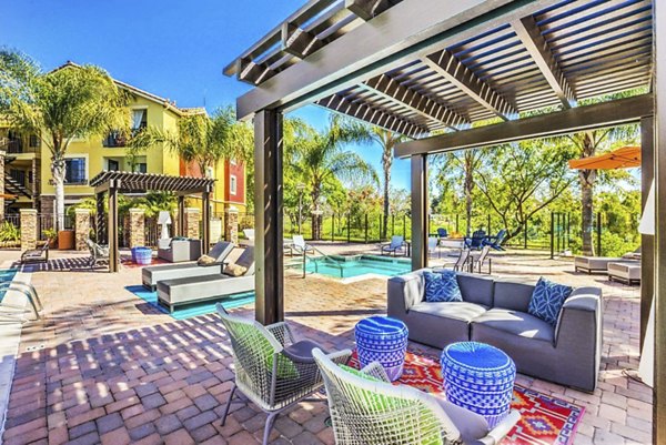 Spacious pool and patio area with lounge chairs at Overlook at Bernardo Heights Apartments, offering luxury amenities and relaxation