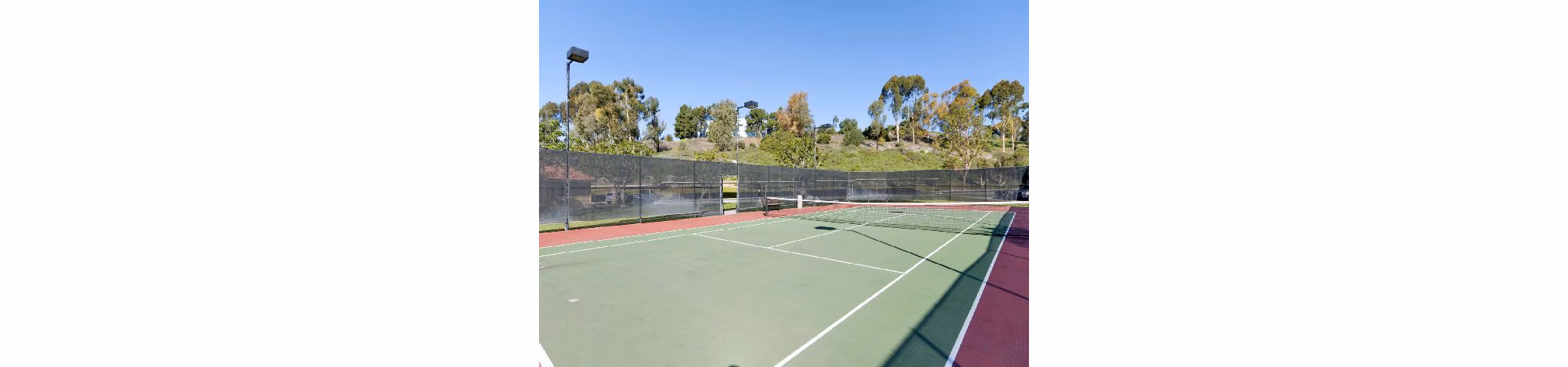 Outdoor sport court with basketball hoops at Overlook at Bernardo Heights Apartments