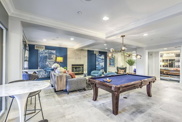 Clubhouse game room featuring pool table and modern seating at Regents Court Apartments