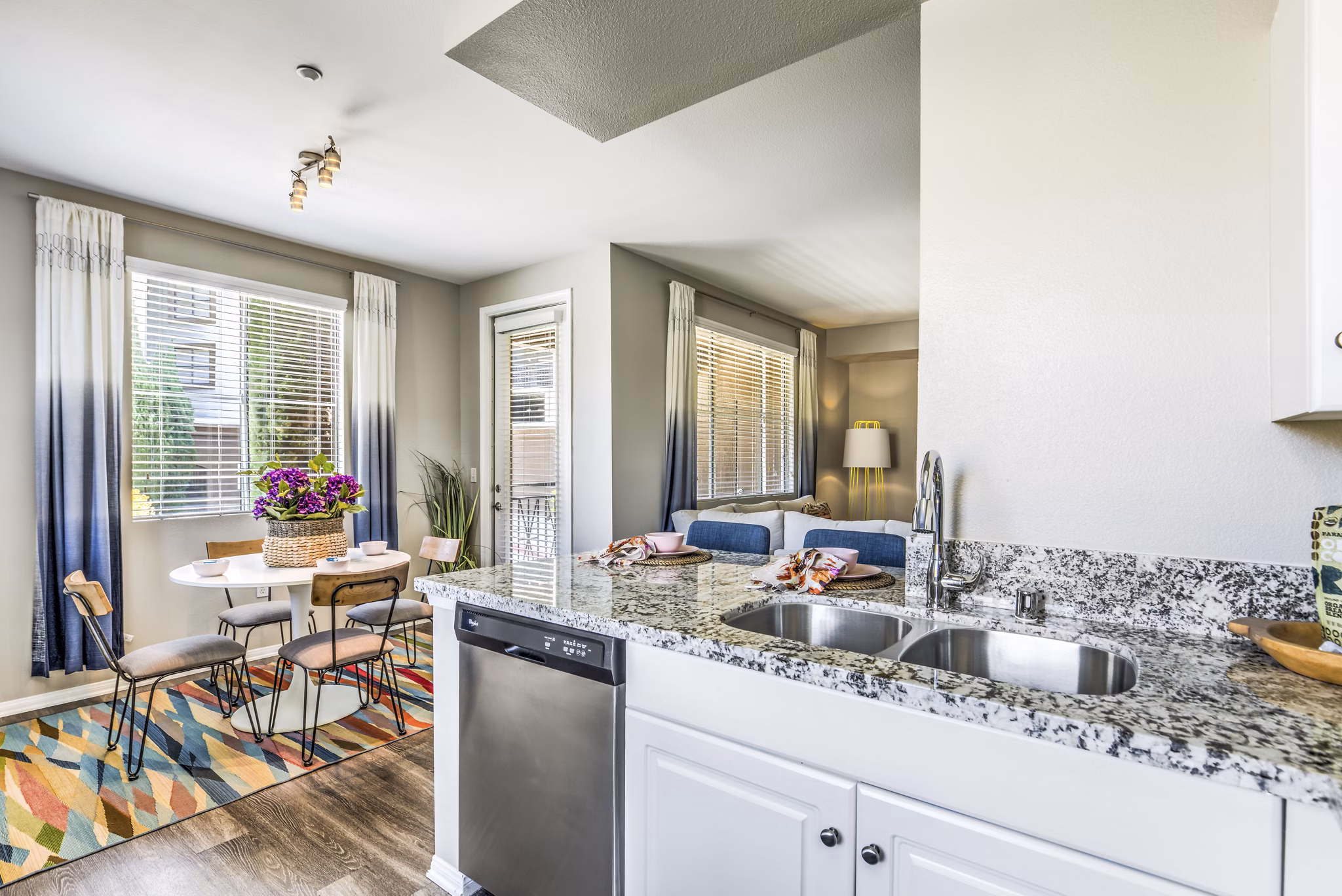 Kitchen with modern appliances and granite countertops in Regents Court Apartments