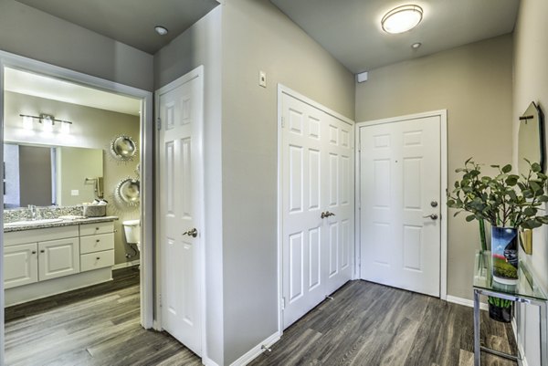 Regents Court Apartments: Modern entry and living room with stylish decor and ample natural light