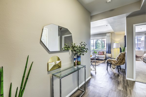 Inviting hallway entry/living room with stylish decor at Regents Court Apartments