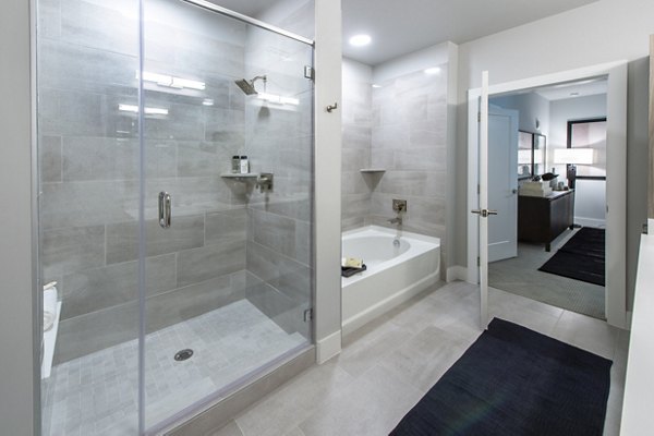 Modern bathroom featuring sleek fixtures and large mirror at Ellison Heights Apartments in vibrant community for luxury living