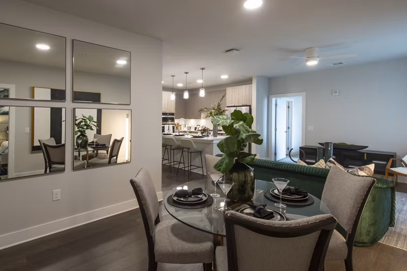 Dining area featuring elegant chandelier and modern furniture at Ellison Heights Apartments