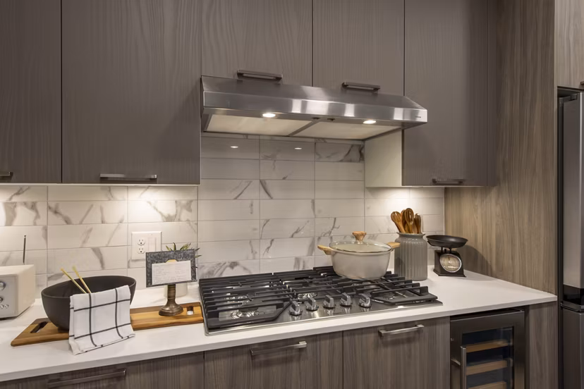 Modern kitchen with stainless steel appliances at Ellison Heights Apartments, luxury living with elegant design and functionality