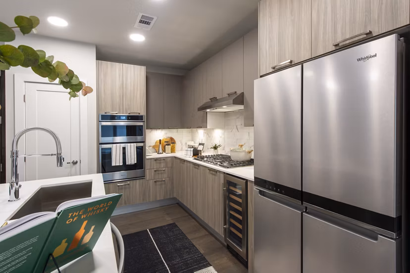 Modern kitchen with stainless steel appliances at Ellison Heights Apartments, luxury living offered by Greystar