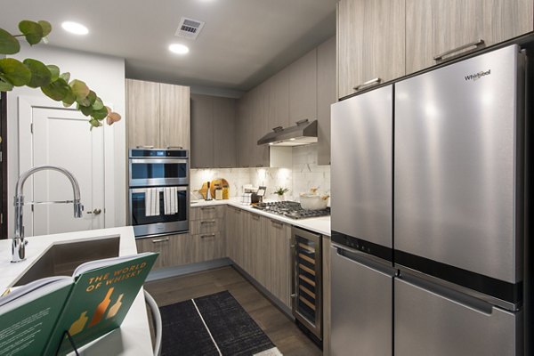 Modern kitchen with stainless steel appliances at Ellison Heights Apartments, luxury living offered by Greystar