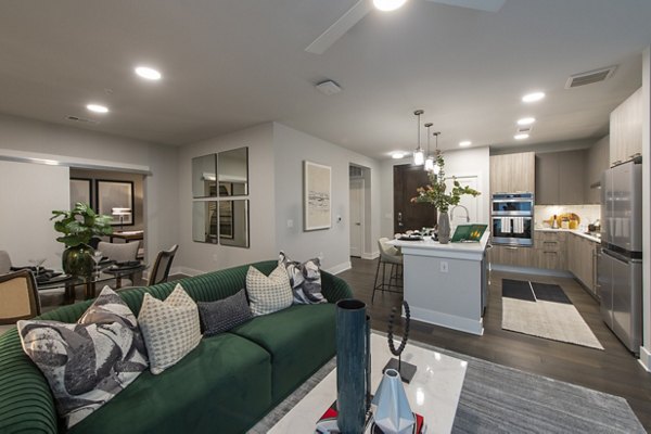 Living room featuring modern furniture and large windows at Ellison Heights Apartments, offering luxury living near shopping and dining