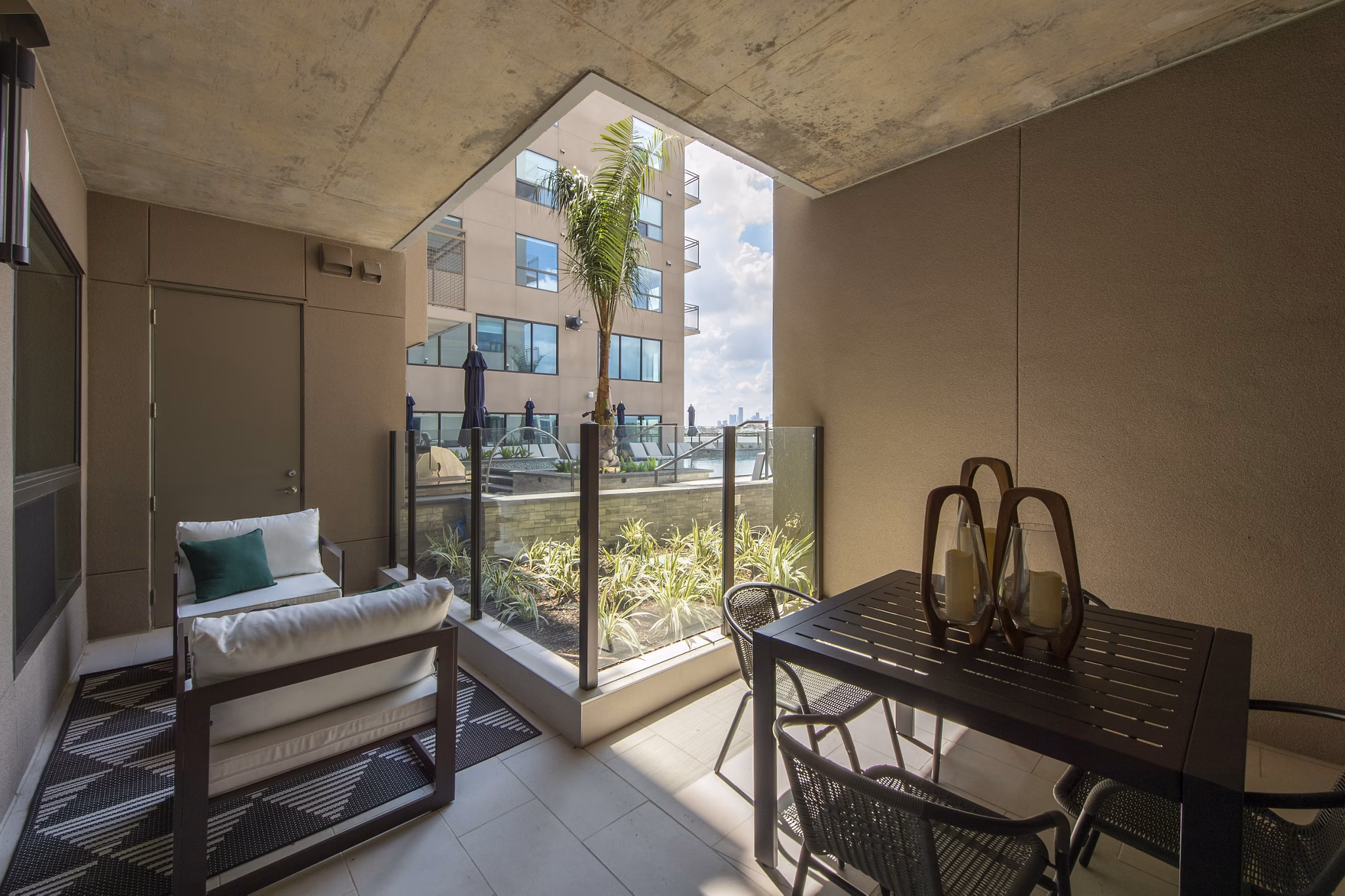 Ellison Heights Apartments: Cozy patio with modern furniture and garden views