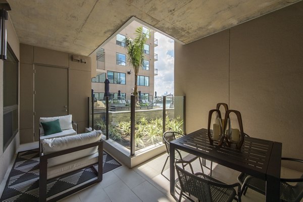 Ellison Heights Apartments: Cozy patio with modern furniture and garden views