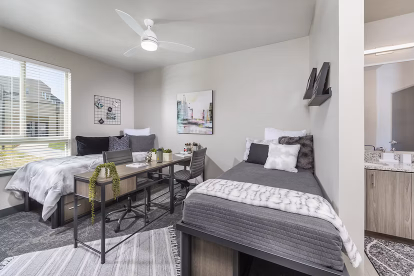 Bedroom with modern furnishings and ample natural light at Hornet Commons Apartments