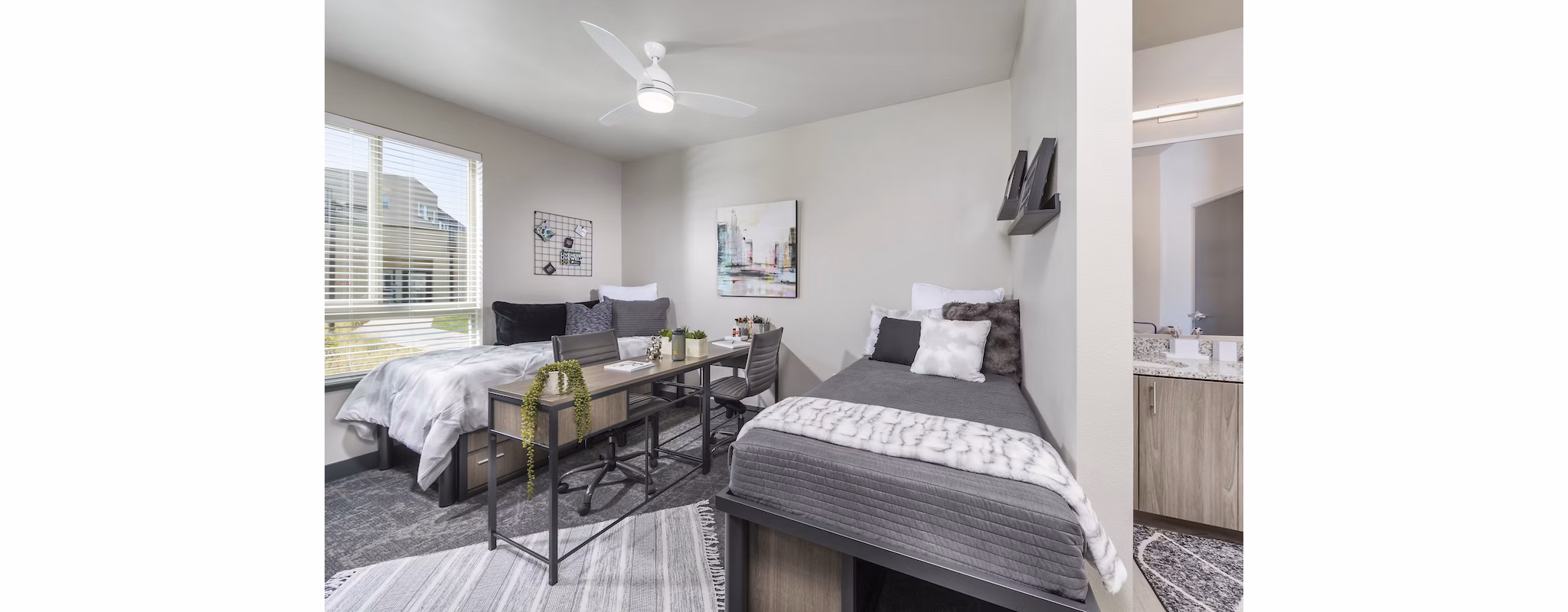 Bedroom with modern furnishings and ample natural light at Hornet Commons Apartments
