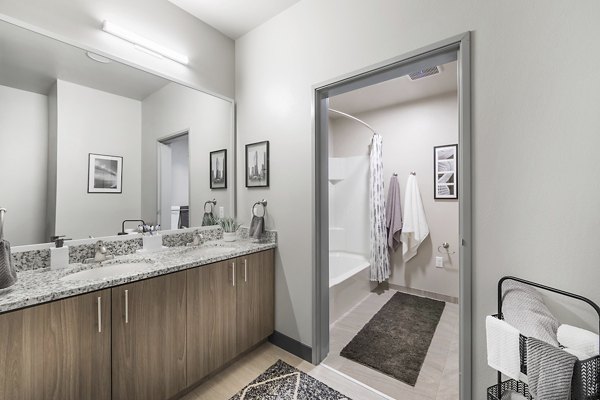 Bathroom with modern fixtures at Hornet Commons Apartments, featuring sleek design and spacious countertops
