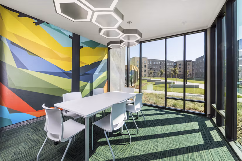 Meeting facility featuring modern design and seating options at Hornet Commons Apartments