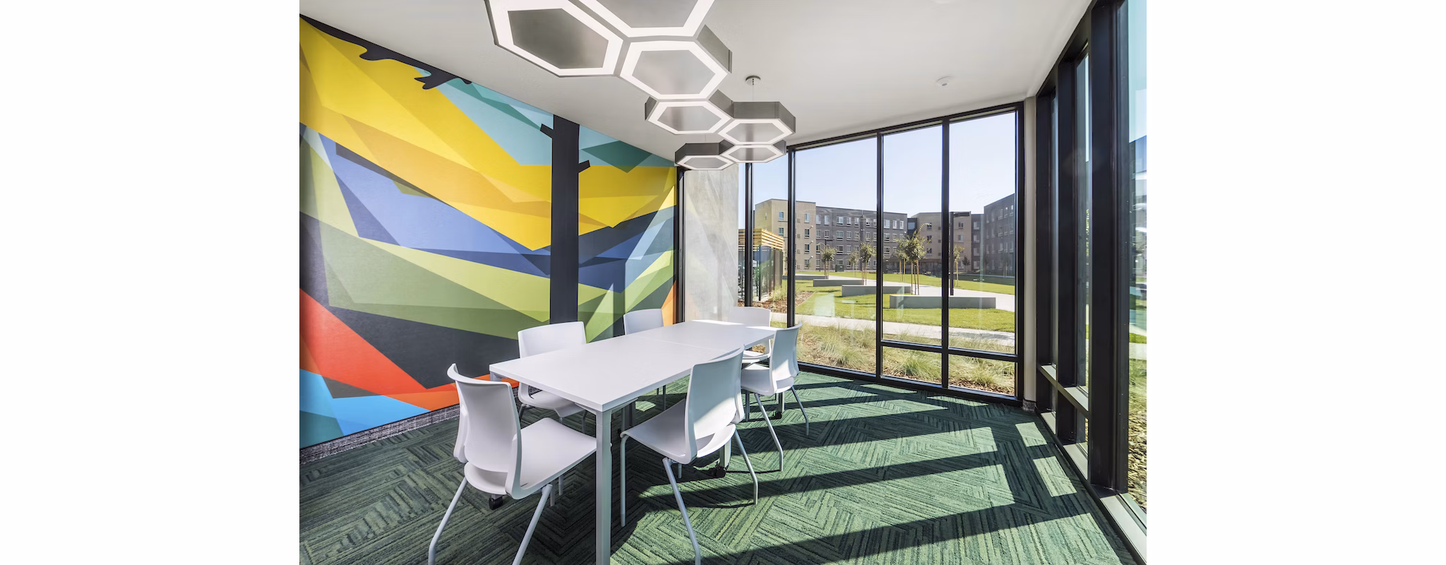 Meeting facility featuring modern design and seating options at Hornet Commons Apartments