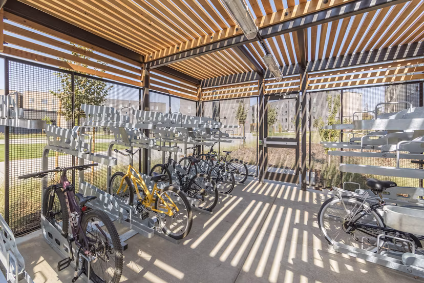 Bike storage room at Hornet Commons Apartments clubhouse featuring secure racks and spacious design
