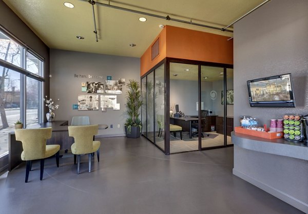 Clubhouse at Museum Park Apartments: Modern community space with plush seating and art decor for residents to socialize and relax