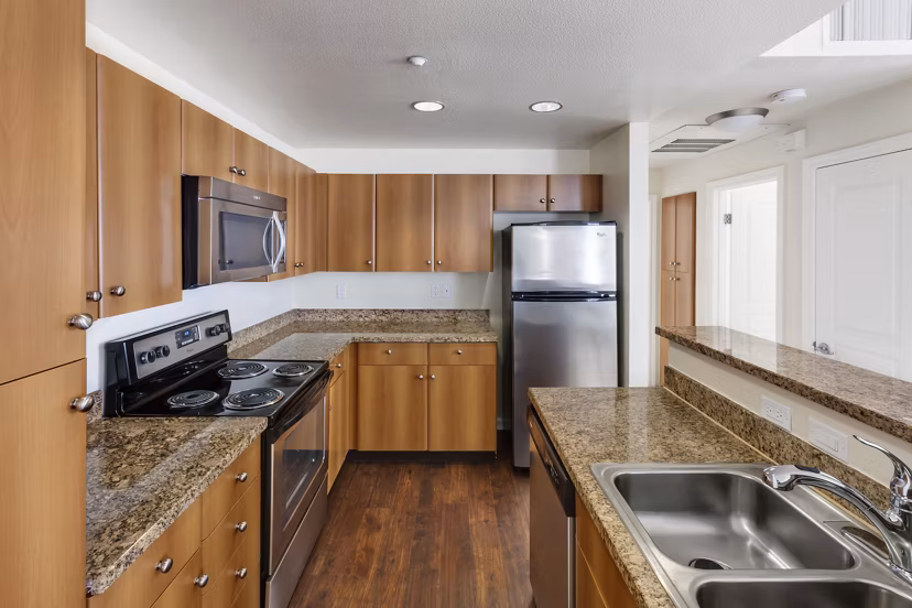 Modern kitchen with stainless steel appliances at Museum Park Apartments