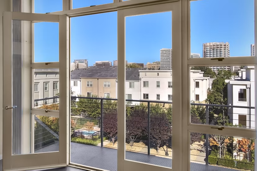Spacious outdoor patio at Museum Park Apartments featuring modern seating and lush greenery