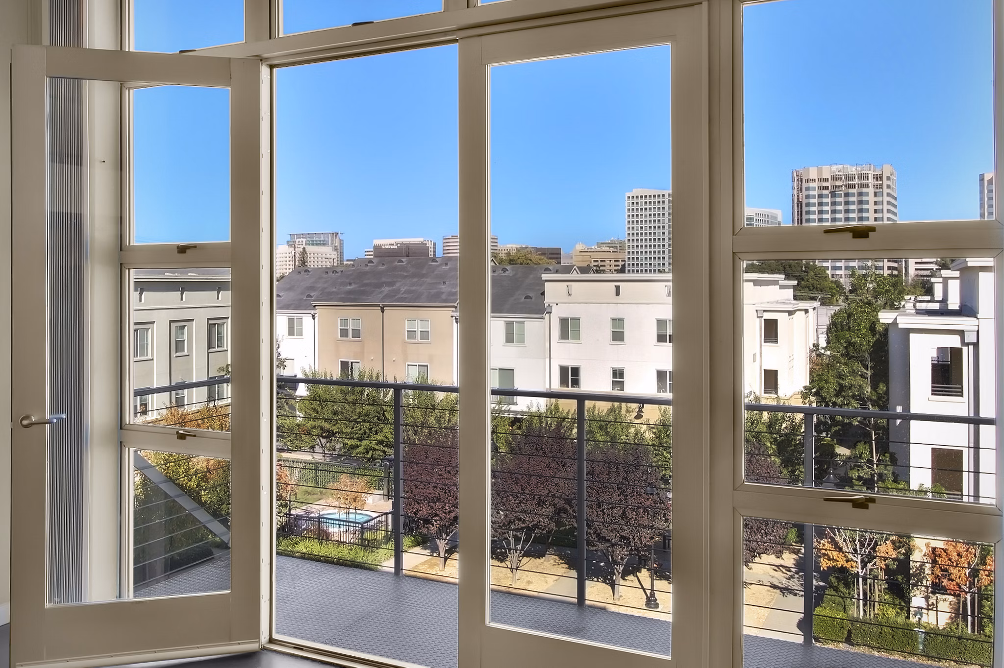 Spacious outdoor patio at Museum Park Apartments featuring modern seating and lush greenery