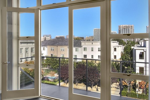 Spacious outdoor patio at Museum Park Apartments featuring modern seating and lush greenery