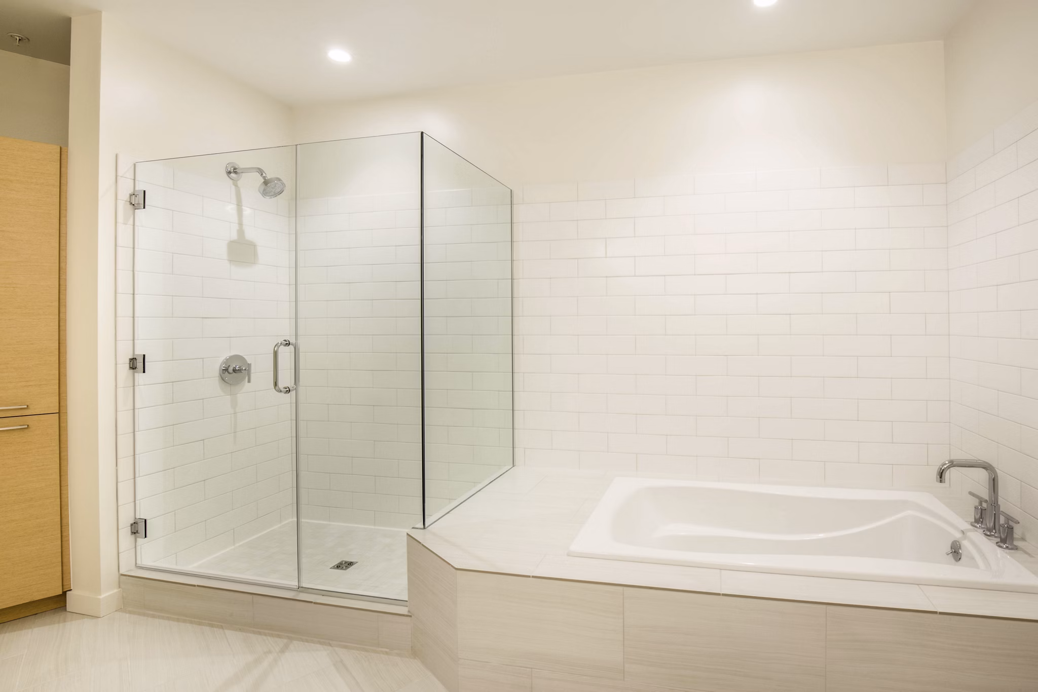 Bathroom with modern fixtures and ample lighting at One South Market Apartments