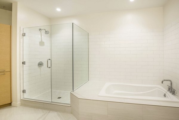 Bathroom with modern fixtures and ample lighting at One South Market Apartments