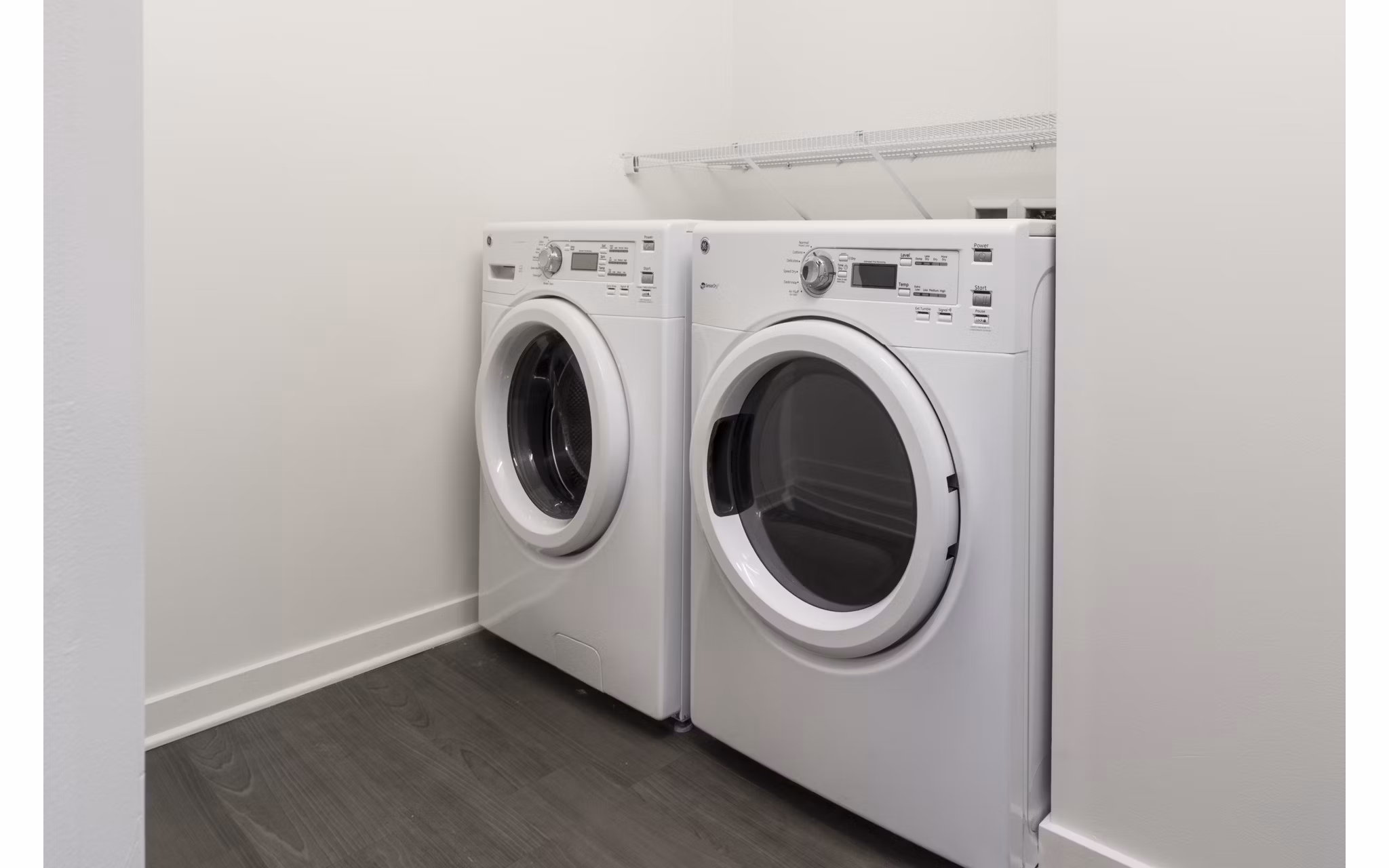 Laundry room with modern appliances at One South Market Apartments