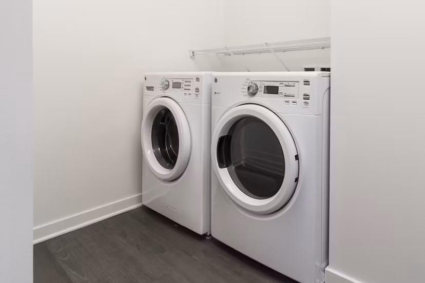 Laundry room with modern appliances at One South Market Apartments