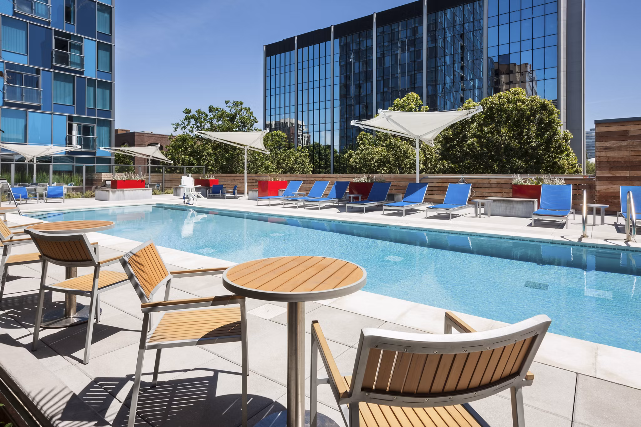 Rooftop outdoor pool at One South Market Apartments offering leisure space and stunning city views