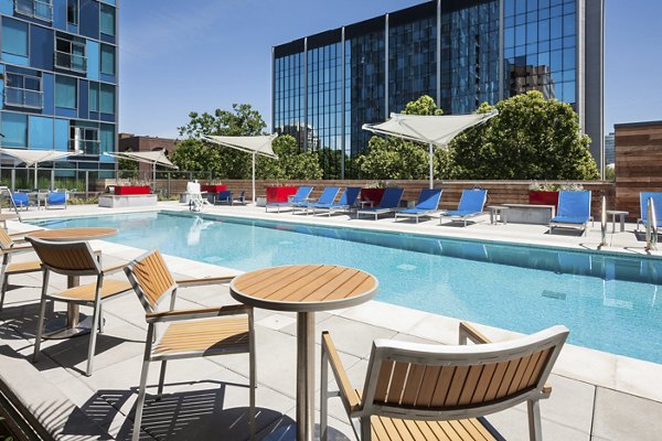 Rooftop outdoor pool at One South Market Apartments offering leisure space and stunning city views