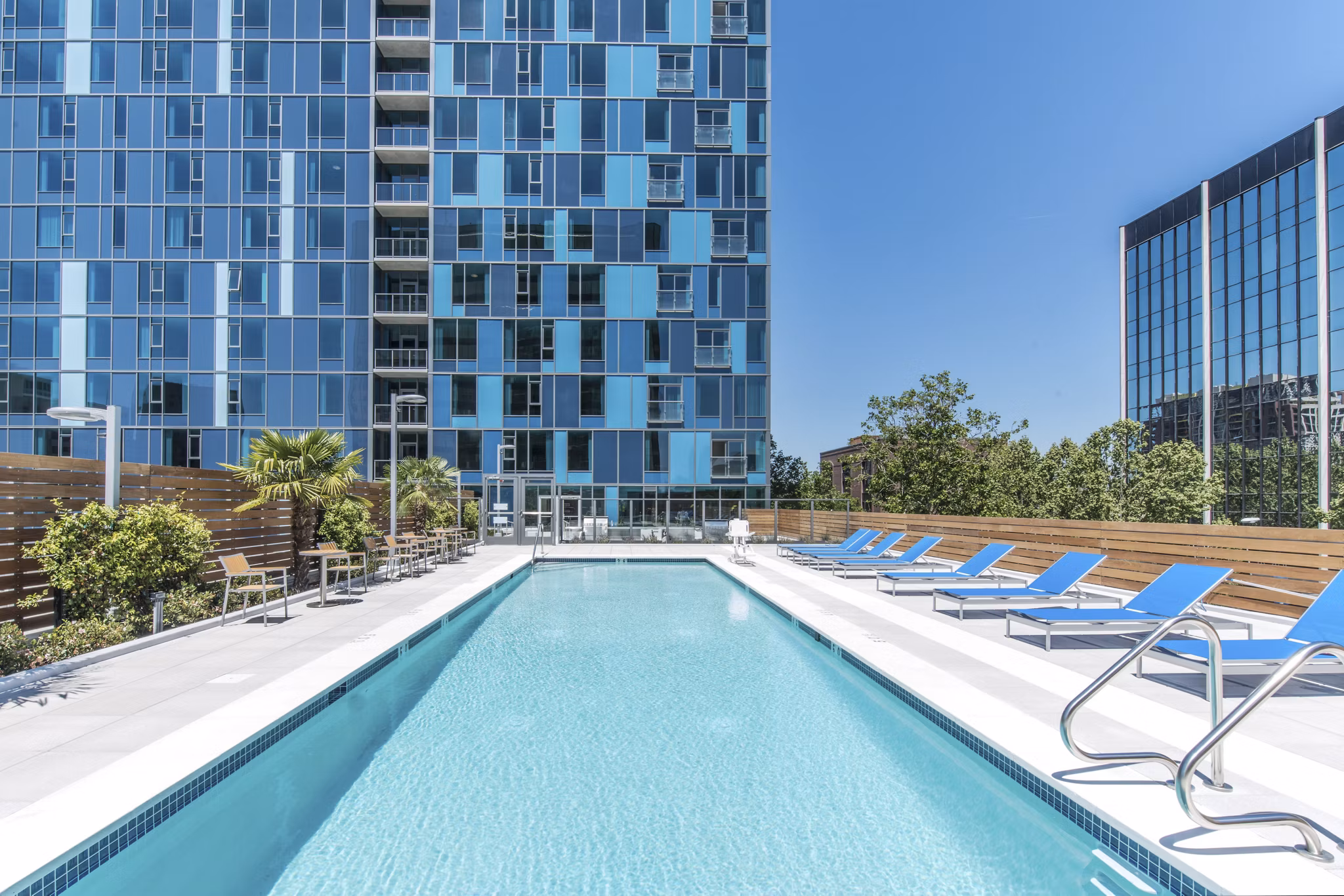 Relaxing outdoor pool with cabanas at One South Market Apartments